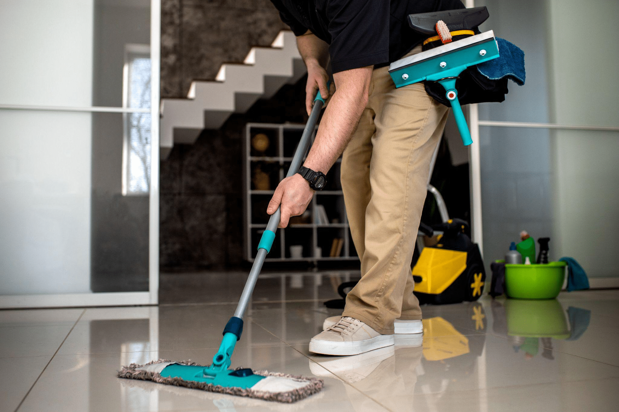 A professional cleaning tile and grout with specialized equipment.